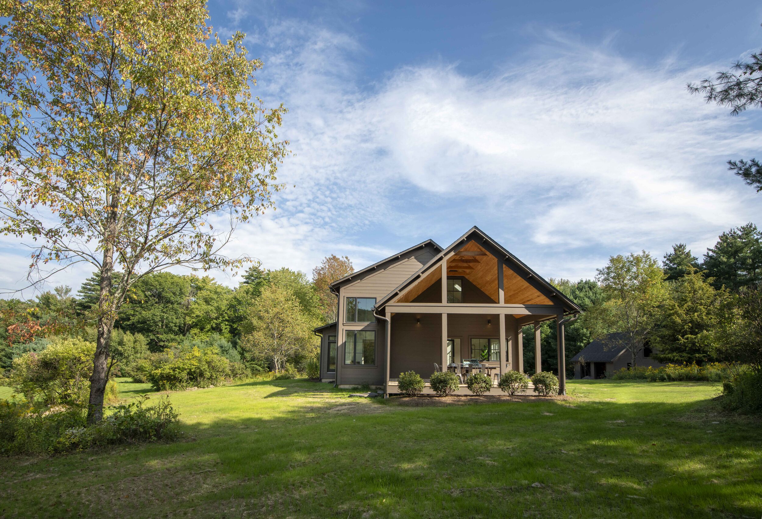 Hemlock House — house and porch seen from across the meadow